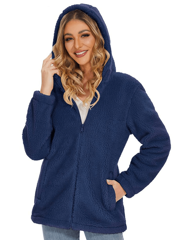 Woman wearing a stylish fluffy women's jacket with hood and zipper, SF0905, perfect for warmth and fashion, color blue, with pockets.